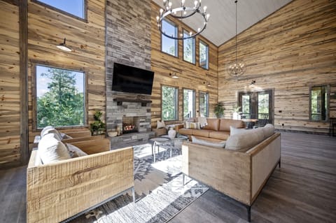 Experience spacious elegance! Our cabin offers a massive open floor plan, seamlessly blending the living and dining areas for a luxurious and inviting atmosphere. Your ideal retreat awaits!