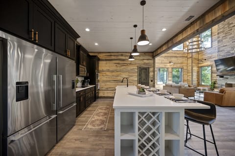 Indulge your culinary senses in our fully stocked kitchen. Featuring a custom double refrigerator, island with a wine rack, and ample space, it's a chef's dream come true. Your culinary adventure begins here!