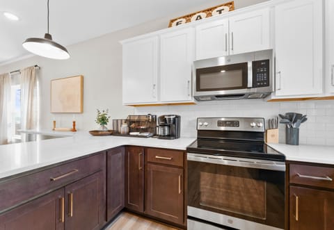 Another view of the kitchen, showcasing the spacious layout and modern appliances that make cooking a breeze.