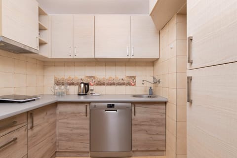 A view showing the open connection between the kitchen and living room. The space is well-organized and functional.