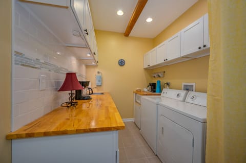 Laundry room area located in lower level of home
