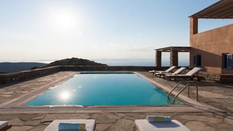 An infinity pool, a heated pool, sun loungers