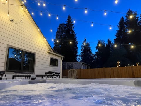 Private backyard with a hot tub and ambient lighting to make your evening more enjoyable.