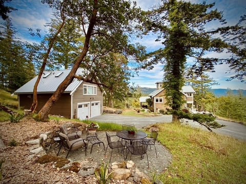 Private outdoor lounge area under Madrona Trees. Main house and Suite shown. 
