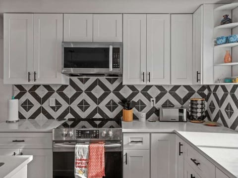 Kitchen picture of Microwave and oven, with our plentiful cabinets that contain plenty of utensils!