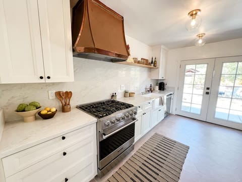 Enjoy the bright and airy kitchen with quartz countertops. Fully stocked. 