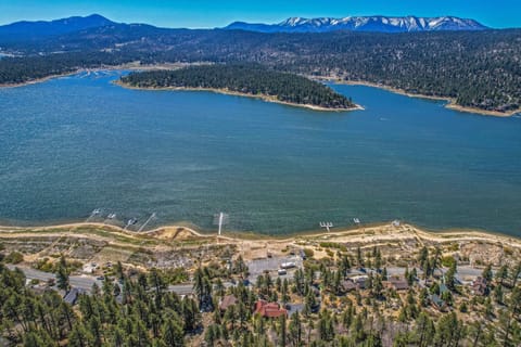Amazing aerial view of home (red roof) with lake and mountain in front.