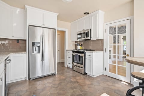Kitchen heading to first floor bedroom and bath