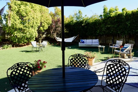 Enormous private fenced backyard with tropical foliage