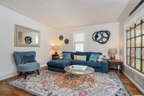 Main floor living space, with lots of cozy seating and natural light coming in. 