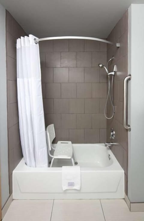Bathroom with shower and tub. Basic toiletries and towels are
