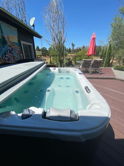 Large private spa right outside your bedroom slider & overlooking the lake.