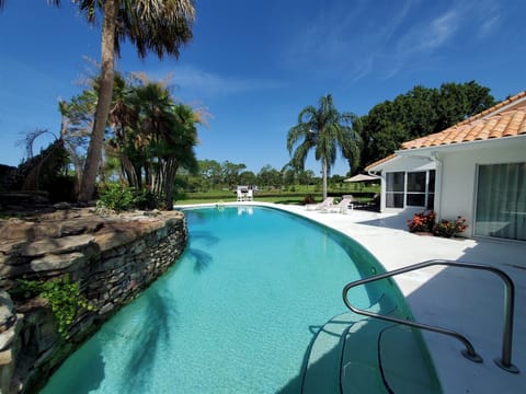 A heated pool, sun loungers