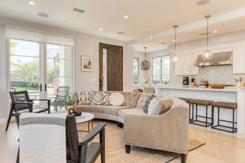 Living room features a fireplace and couch, perfect for a movie night after swimming and surfing at Corona Del Mar State Beach Park (a 4-minute drive away).