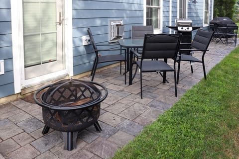 Our backyard patio area is equipped with a grill, outdoor dining area, & firepit