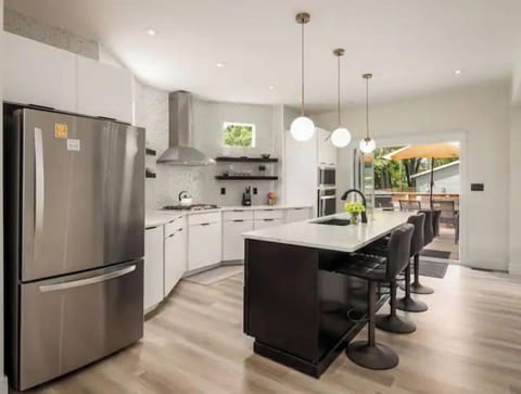 Kitchen features a cook-top gas stove, dishwasher, wall microwave and oven!