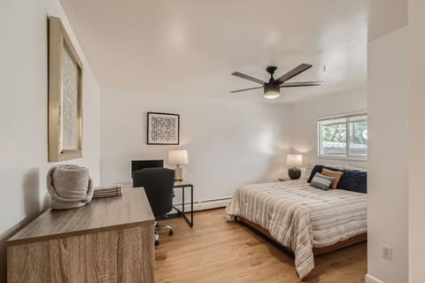 Bedroom 2 has a queen bed, a desk, and monitor