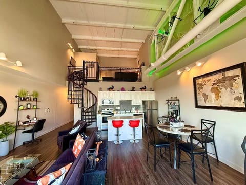 Full Loft Kitchen & Dining
Spiral stairs, festive webs, and pumpkin décor bring spooky elegance to this open kitchen and dining space.