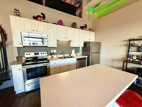 Kitchen with Island
Bright and modern kitchen paired with festive Halloween décor — pumpkins, skulls, and glowing accents above.