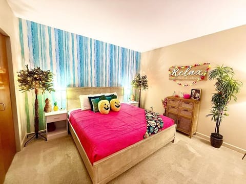 Bedroom with Pumpkin Pillows
Relax in a tropical-meets-Halloween escape, complete with glowing palms, playful pumpkin pillows, and festive touches for a cozy seasonal retreat.