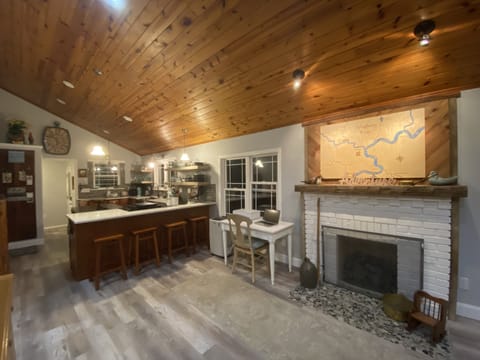 Counter seating for 4 and desk with printer with a cozy gas log fireplace.