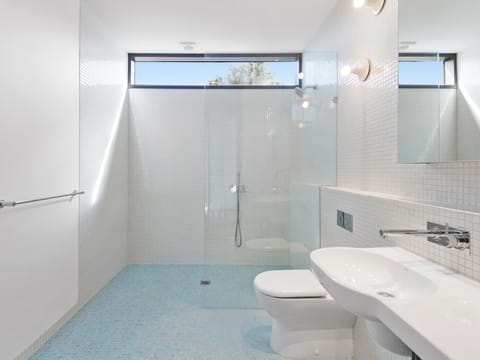 Spacious bathroom featuring shower and toilet