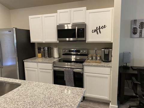 Fully stocked kitchen featuring coffee bar, RO water, pots, pans, dishes, silver