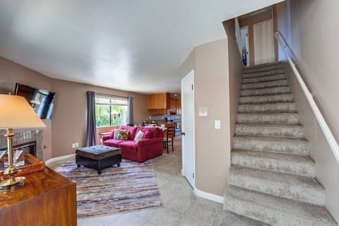 Front door entrance shows open living space and stairs to second floor with additional 2 bedrooms.