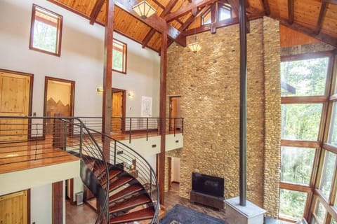 A grand living room featuring soaring ceilings and the eye-catching spiral staircase.