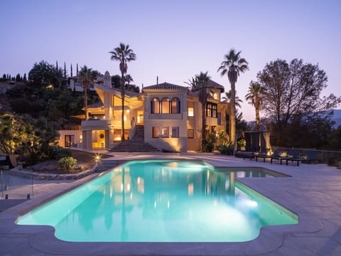 An infinity pool, a heated pool, sun loungers