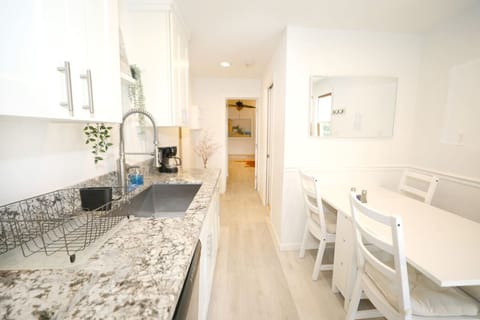 Bright and fully stocked kitchen. Everything you need from pots and pans, to appliances, dishware and more and. Gas stove with oven, dishwasher, full size refrigerator and cozy dining table.