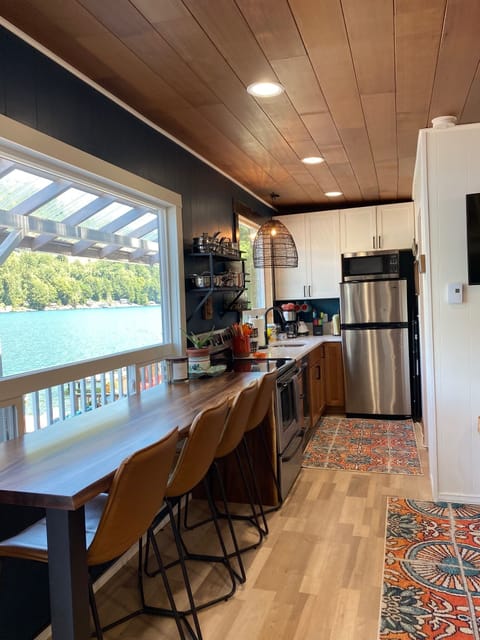 Main level fully equipped kitchen with lake views and counter seating