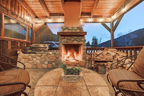 Stunning outdoor fireplace with provided wood.
