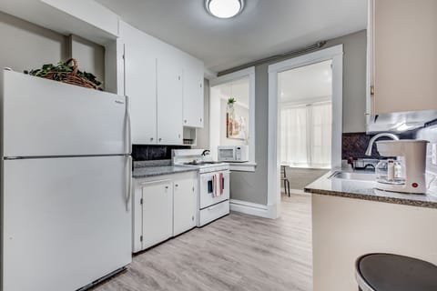 Fully-stocked kitchen with fridge, stove, oven, microwave, kettle, coffee maker