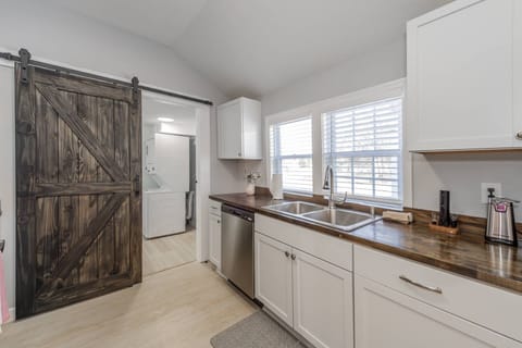 You can find the laundry room behind the sliding door off the kitchen
