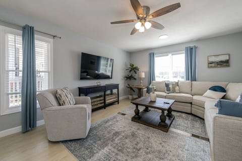 The living room offers a plush sectional and Smart TV to stream all your favorite apps