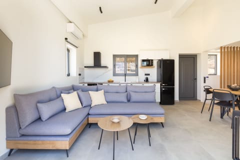 The modern open-plan living space includes a dining area.