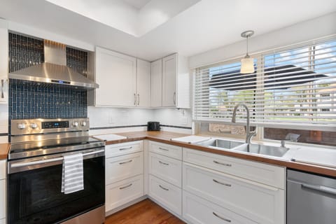 The window above the kitchen sink provides the space with ample bright light and a view to the world.