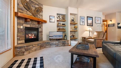 Open concept living room with a full size sofa sleeper, HDTV with streaming capabilities, and a gas fireplace to enjoy after a long day on the slopes.