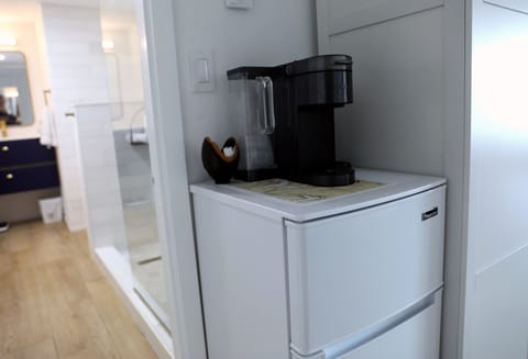 Small refrigerator and coffee machine in bedroom