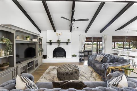 [Living area] 65" Smart TV & sliding doors leading to outdoor entertainment area