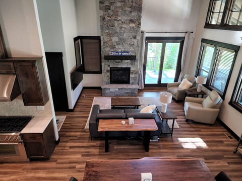 Open living space with sofa, recliners, smart TV, and fireplace