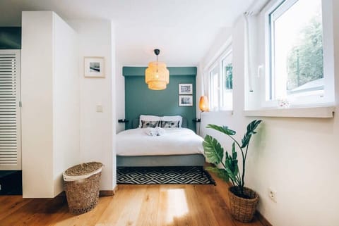 Cozy bedroom with a comfortable bed and plenty of natural light, ensuring a restful night's sleep in a serene setting.