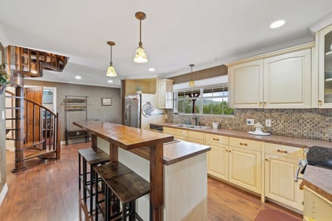 kitchen bar stools coffee area and upstairs stairway