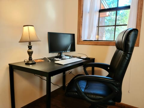 Work remotely amidst nature - a setup w monitor, keyboard, mouse in main bedroom