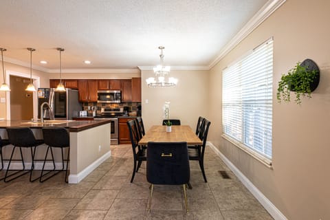 The dining room, conveniently located near the kitchen, has a view of the back yard and offers seating for up to 8 guests.