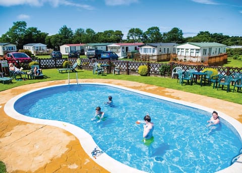 Outdoor pool | The Village Holiday Park, Cross Inn, Nr New Quay