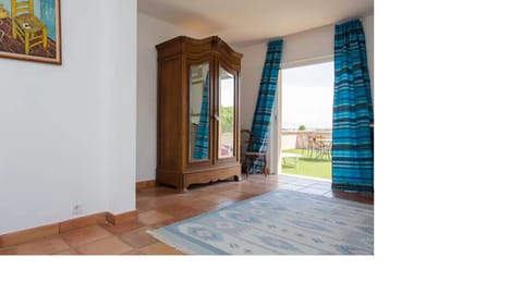 Master bedroom suite with French doors onto large upper terrace distant sea view