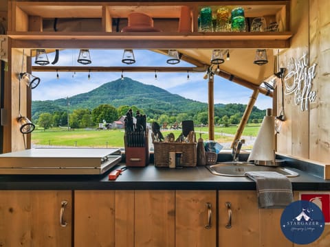 Enjoy a stunning view while preparing hearty camp meals on the 4 burner gas stove.