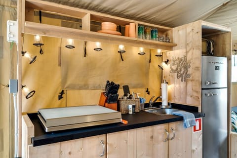 This entire flap can be rolled up to reveal a pass through out door bar!